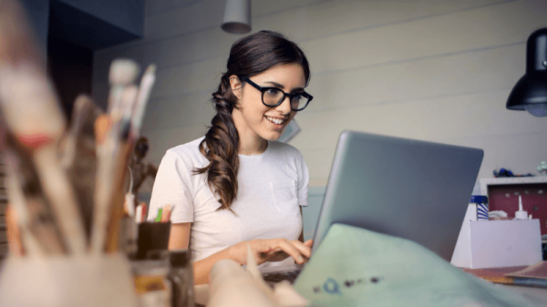 Woman with glasses looking at laptop